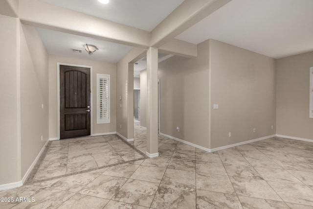 foyer with baseboards and visible vents