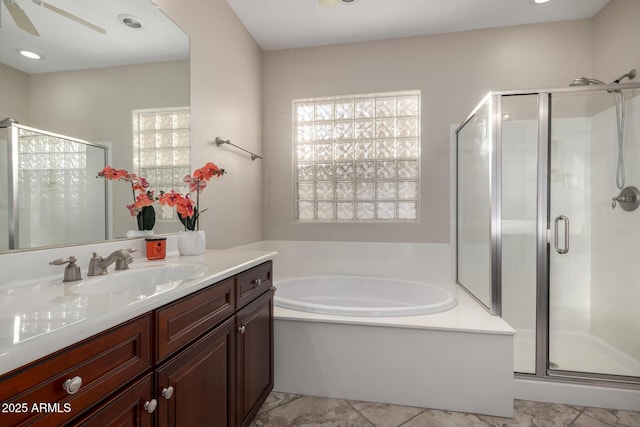 bathroom featuring a garden tub, ceiling fan, vanity, a shower stall, and tile patterned floors