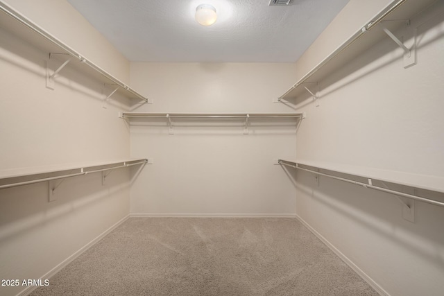 walk in closet with carpet floors and visible vents