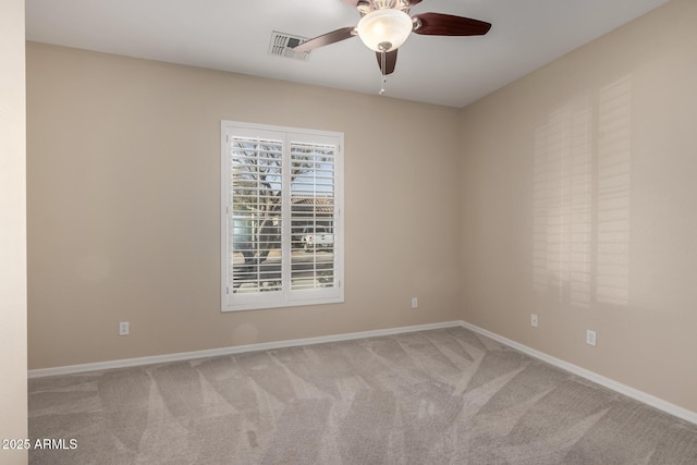 empty room featuring baseboards, visible vents, ceiling fan, and light colored carpet