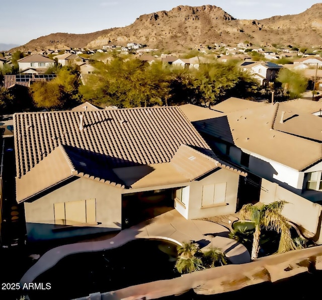 drone / aerial view featuring a residential view and a mountain view