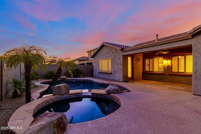 view of pool with a ceiling fan, a patio area, a fenced backyard, and a pool with connected hot tub