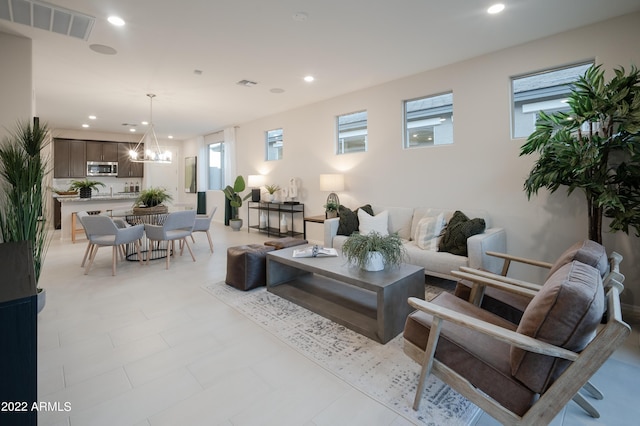 living room featuring plenty of natural light and an inviting chandelier