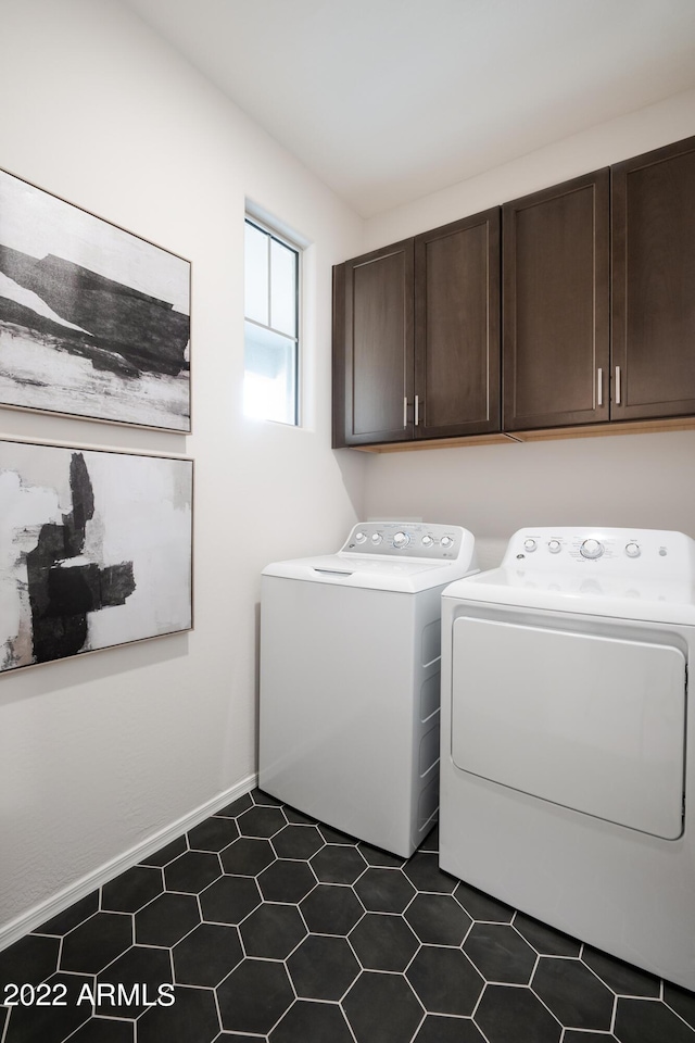 laundry room featuring cabinets and washing machine and clothes dryer