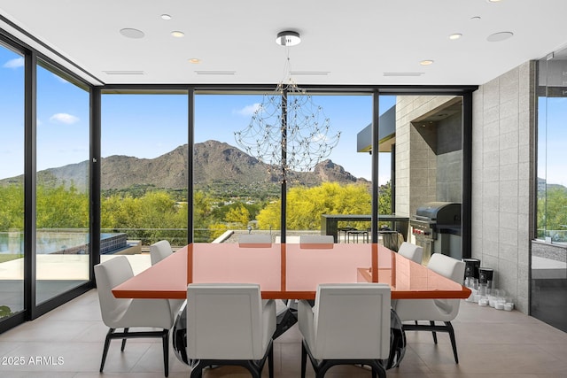 sunroom with a mountain view and a healthy amount of sunlight