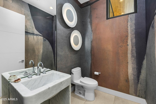 bathroom with tile patterned flooring, sink, and toilet