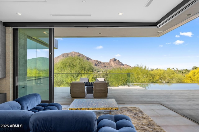 doorway to outside with a water and mountain view and floor to ceiling windows