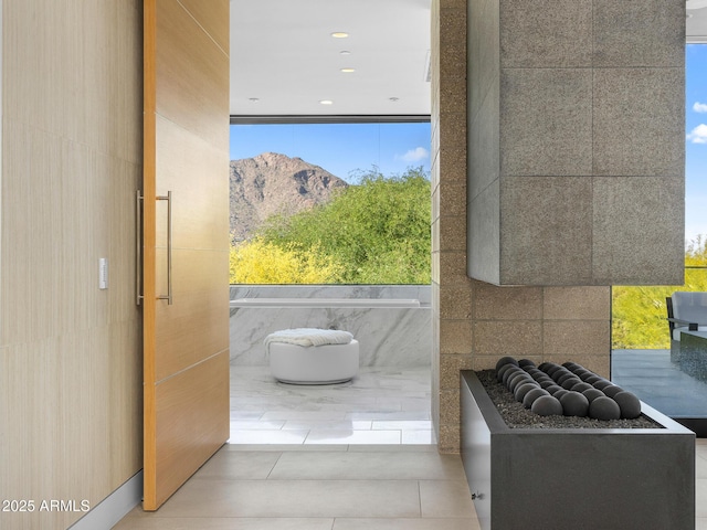 doorway with a mountain view and tile patterned flooring