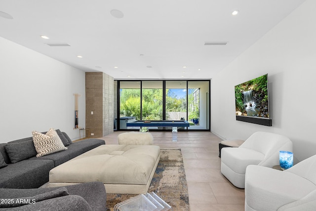 living room featuring expansive windows and billiards