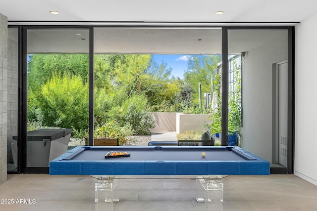 rec room featuring pool table and expansive windows