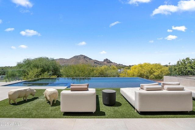 view of swimming pool with a mountain view