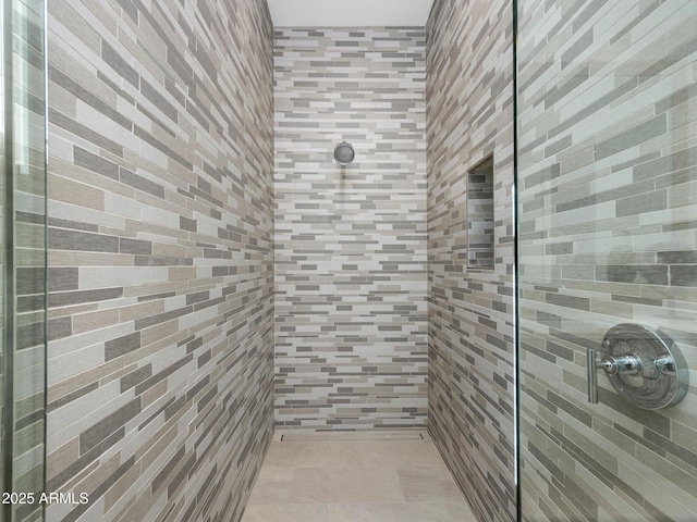 bathroom with a tile shower