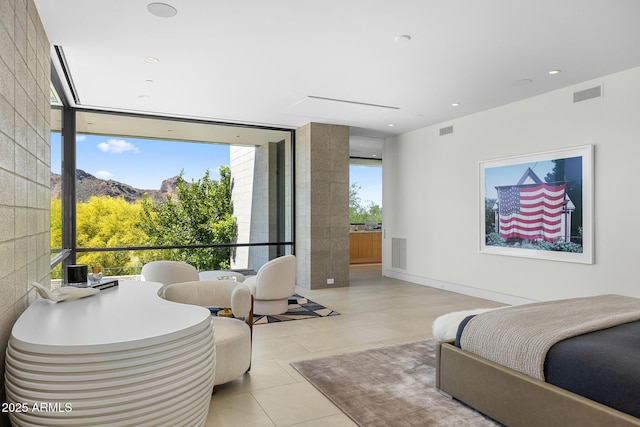 tiled bedroom with multiple windows, a mountain view, and expansive windows