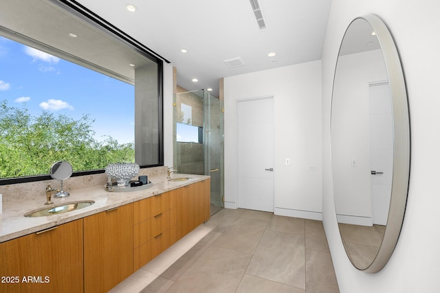 bathroom featuring vanity, tile patterned floors, and walk in shower