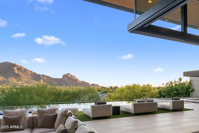 view of patio / terrace featuring a water and mountain view and outdoor lounge area