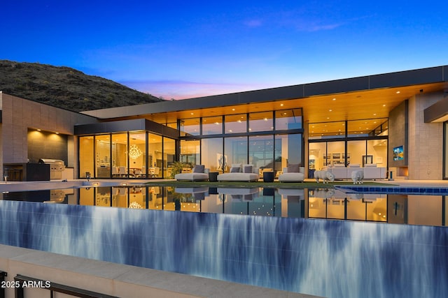 view of pool at dusk