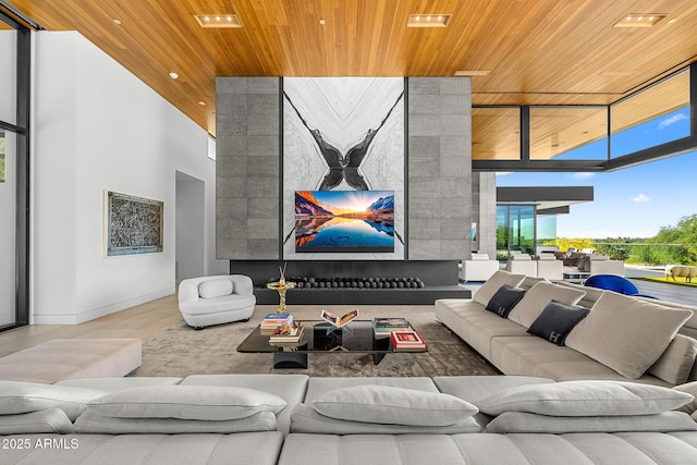 living room with a high ceiling, floor to ceiling windows, and wood ceiling