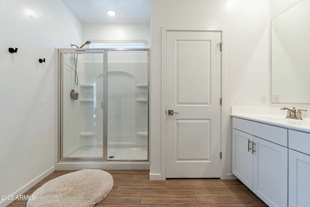 bathroom with vanity and a shower with door