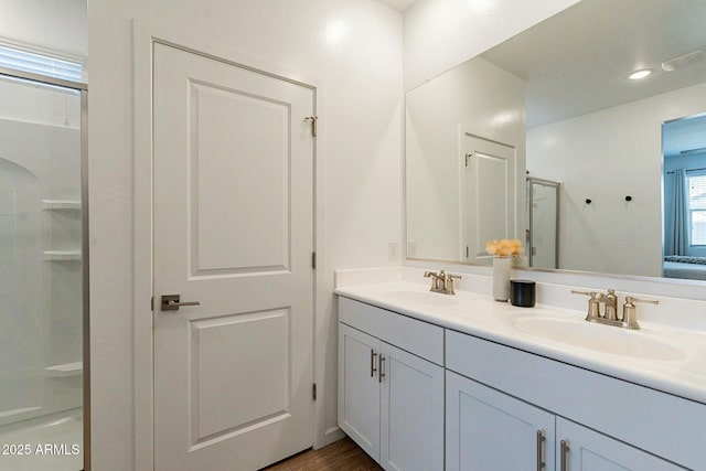 bathroom featuring vanity and a shower with shower door