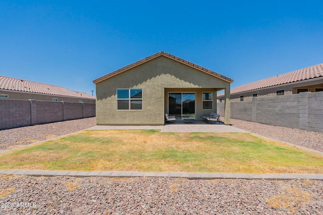 rear view of house featuring a patio and a lawn