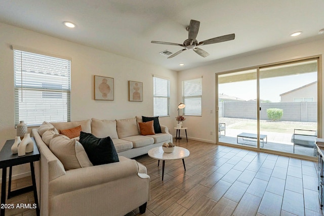 living room featuring ceiling fan and a healthy amount of sunlight