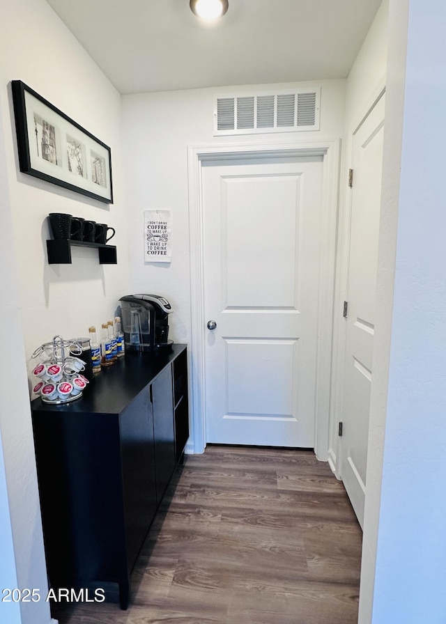 doorway to outside featuring dark wood-type flooring
