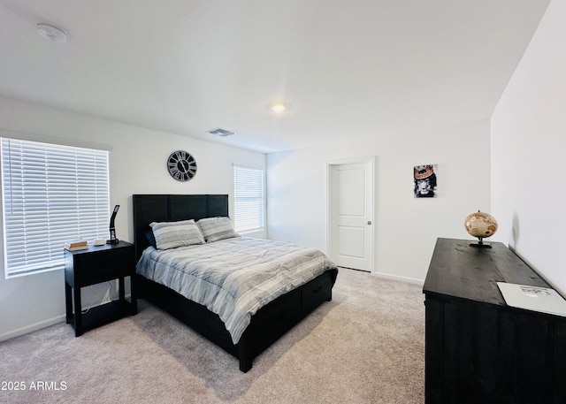 bedroom featuring light carpet and baseboards