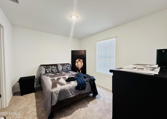 carpeted bedroom featuring baseboards