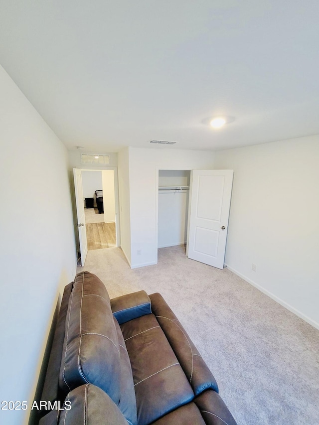 carpeted living area with baseboards