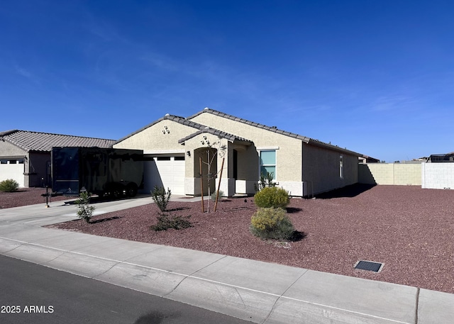 ranch-style house with a garage, fence, stucco siding, concrete driveway, and a tile roof