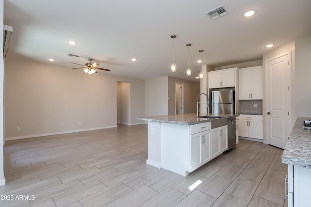 kitchen featuring visible vents, ceiling fan, hanging light fixtures, stainless steel appliances, and white cabinetry