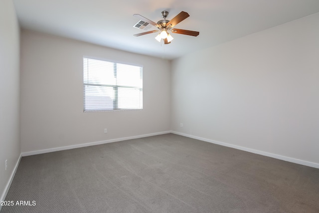 empty room featuring baseboards, carpet floors, visible vents, and ceiling fan