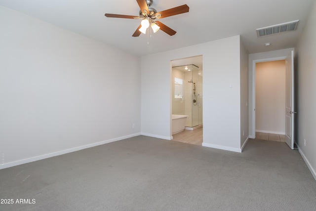 unfurnished bedroom featuring visible vents, carpet flooring, connected bathroom, and baseboards