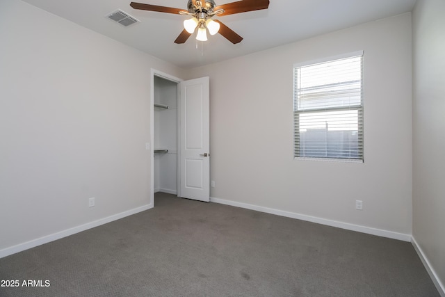 unfurnished bedroom featuring visible vents, baseboards, carpet, and ceiling fan