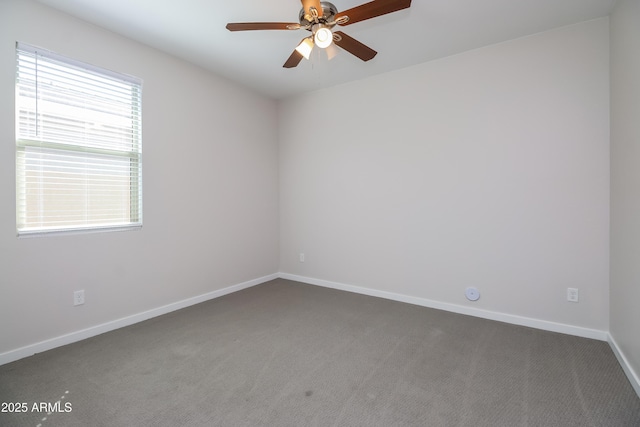 unfurnished room featuring baseboards, carpet, and a ceiling fan