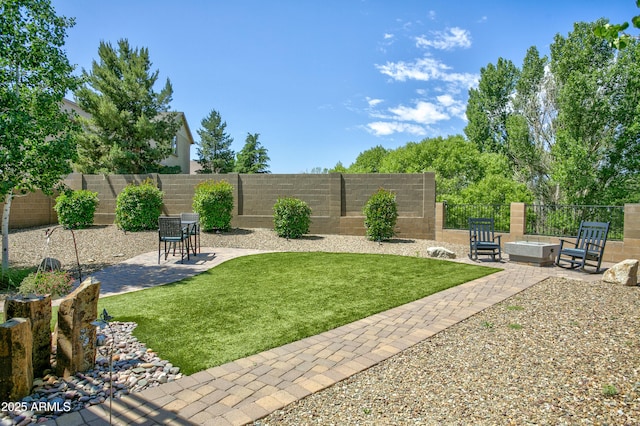 932 N Gomez St, Dewey, AZ 86327 - fenced backyard featuring a patio area and a fire pit