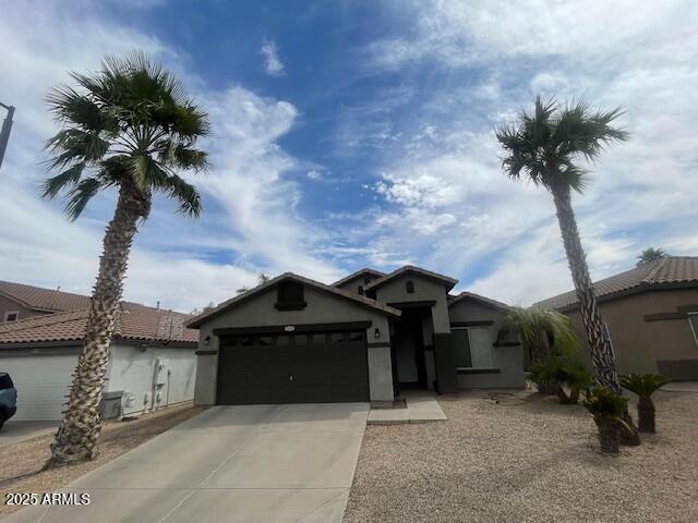 single story home featuring an attached garage, stucco siding, and concrete driveway