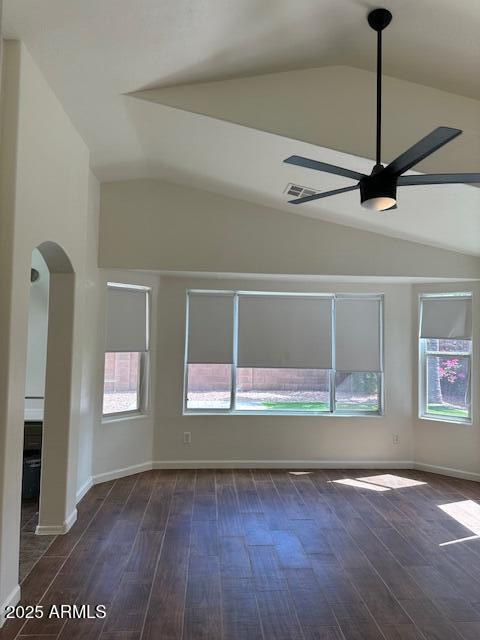 unfurnished living room featuring dark wood-type flooring, a ceiling fan, and vaulted ceiling