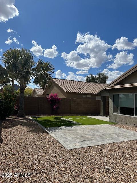 view of yard featuring fence and a patio area