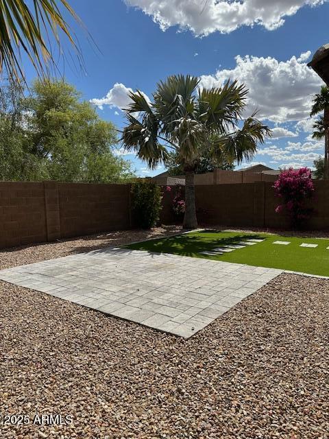 view of yard with a fenced backyard and a patio area