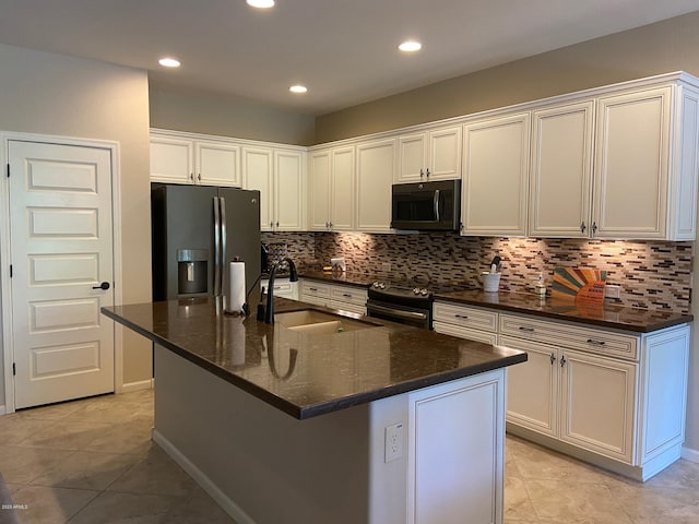 kitchen featuring white cabinetry, sink, stainless steel appliances, and an island with sink