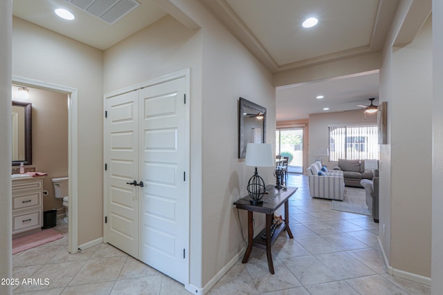 hall featuring light tile patterned floors