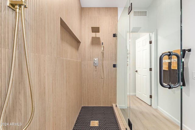 bathroom featuring hardwood / wood-style floors and walk in shower