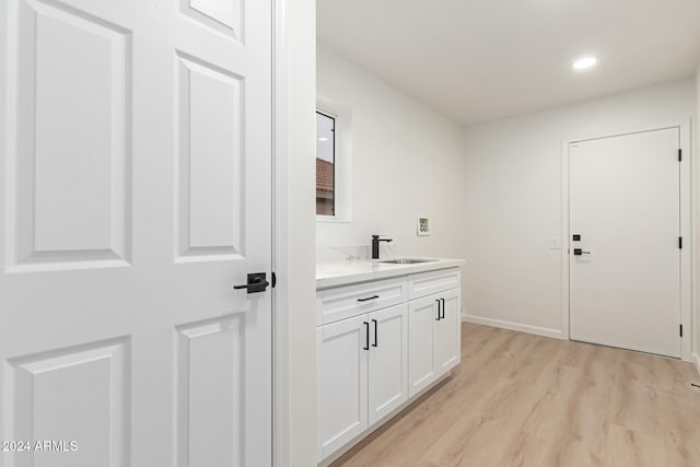 interior space with light hardwood / wood-style floors and sink