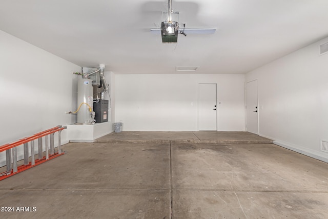 garage with a garage door opener and water heater