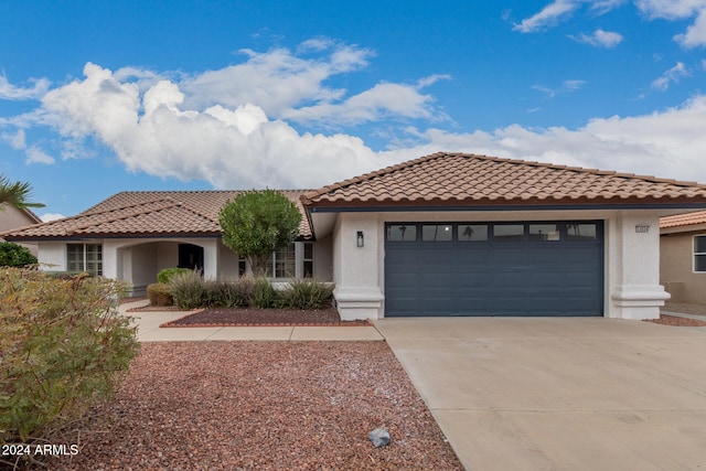 mediterranean / spanish-style home with a garage