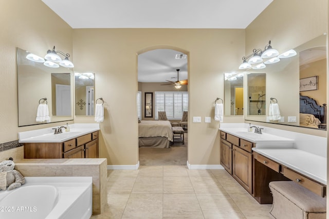 bathroom with ceiling fan, a washtub, tile patterned floors, and vanity