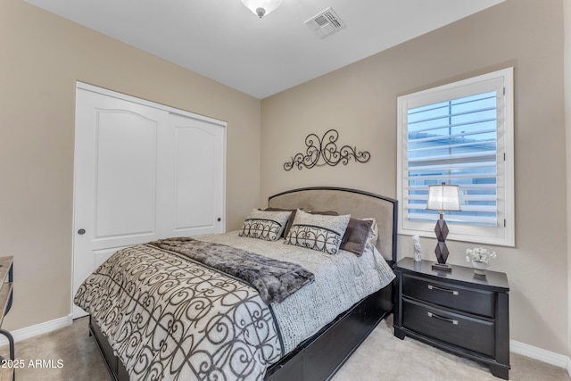 bedroom with a closet and light colored carpet