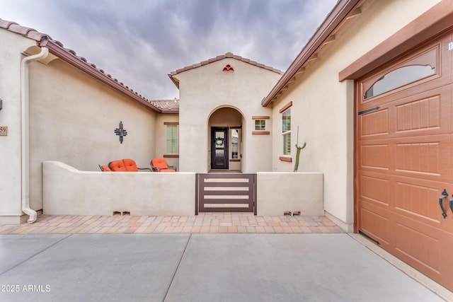 doorway to property with a patio and a garage