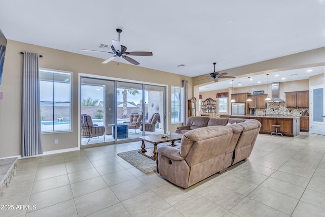 tiled living room with ceiling fan